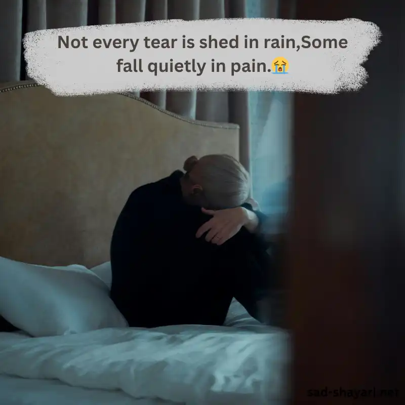 A girl sitting alone near a lake, symbolizing silent emotional pain — matching the quote Not every tear is shed in rain, some fall quietly in pain